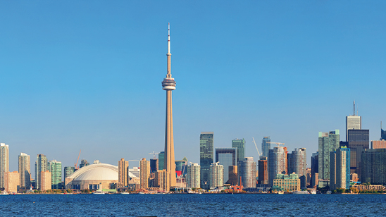 Toronto skyline panorama over lake with urban architecture.