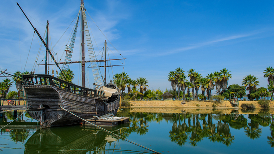 A traditional wooden ship is moored up in a harbour on Rabida, Galapagos Islands