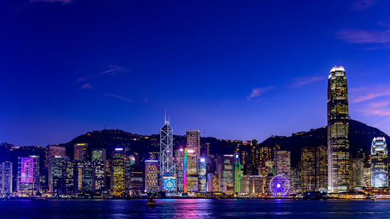 Hong Kong skyline from Victoria Harbour, illuminated in the evening