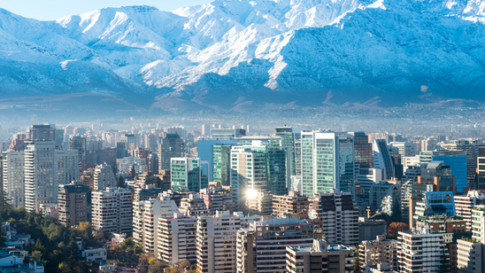 Panoramic view of skyscrapers in Santiago, Chile, with the snow-covered Andes in the background