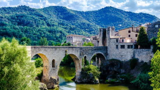 The famous medieval bridge over the river Fluvia in the medieval village of BesalÃº, Girona, Catalonia, Spain