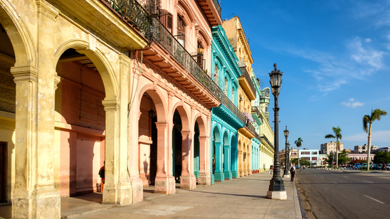 Colourfully painted buildings line a street in Havana, Cuba